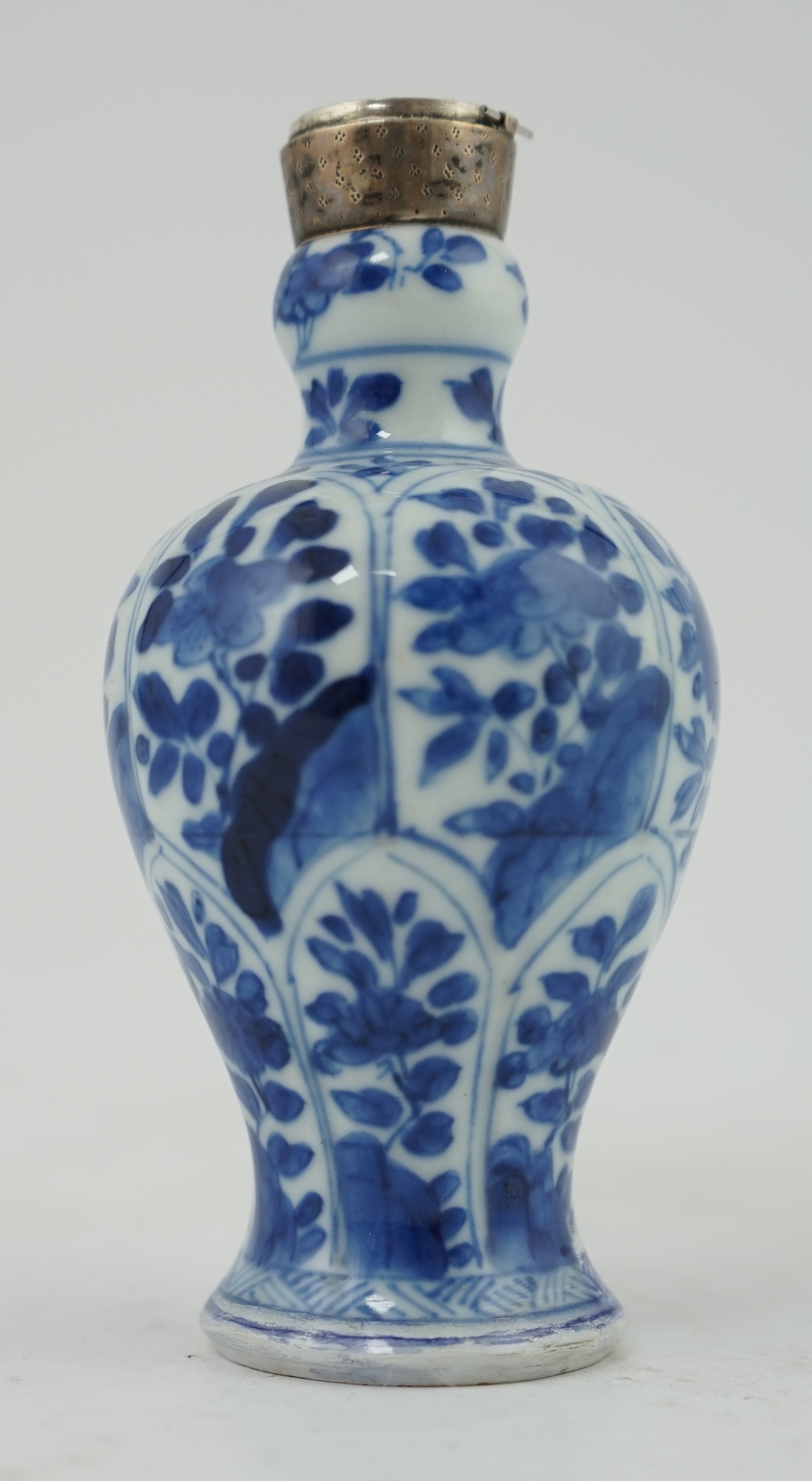 A Chinese small blue and white, white metal mounted vase, Kangxi, 12cm. Condition - poor to fair